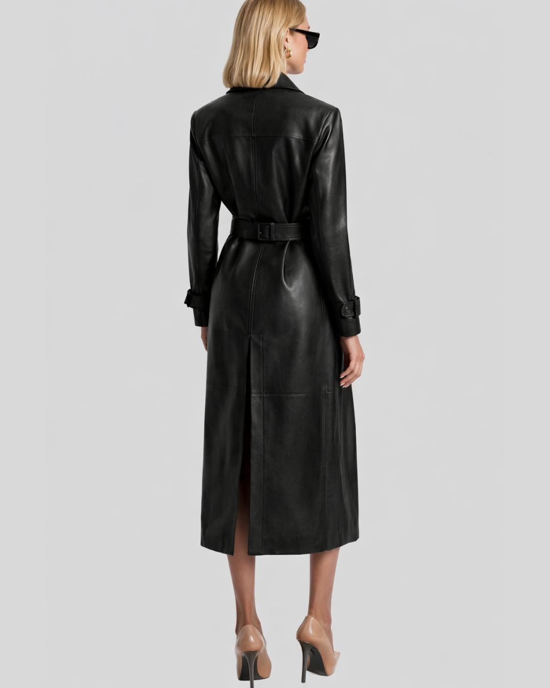 Back view of belted black leather trench coat women