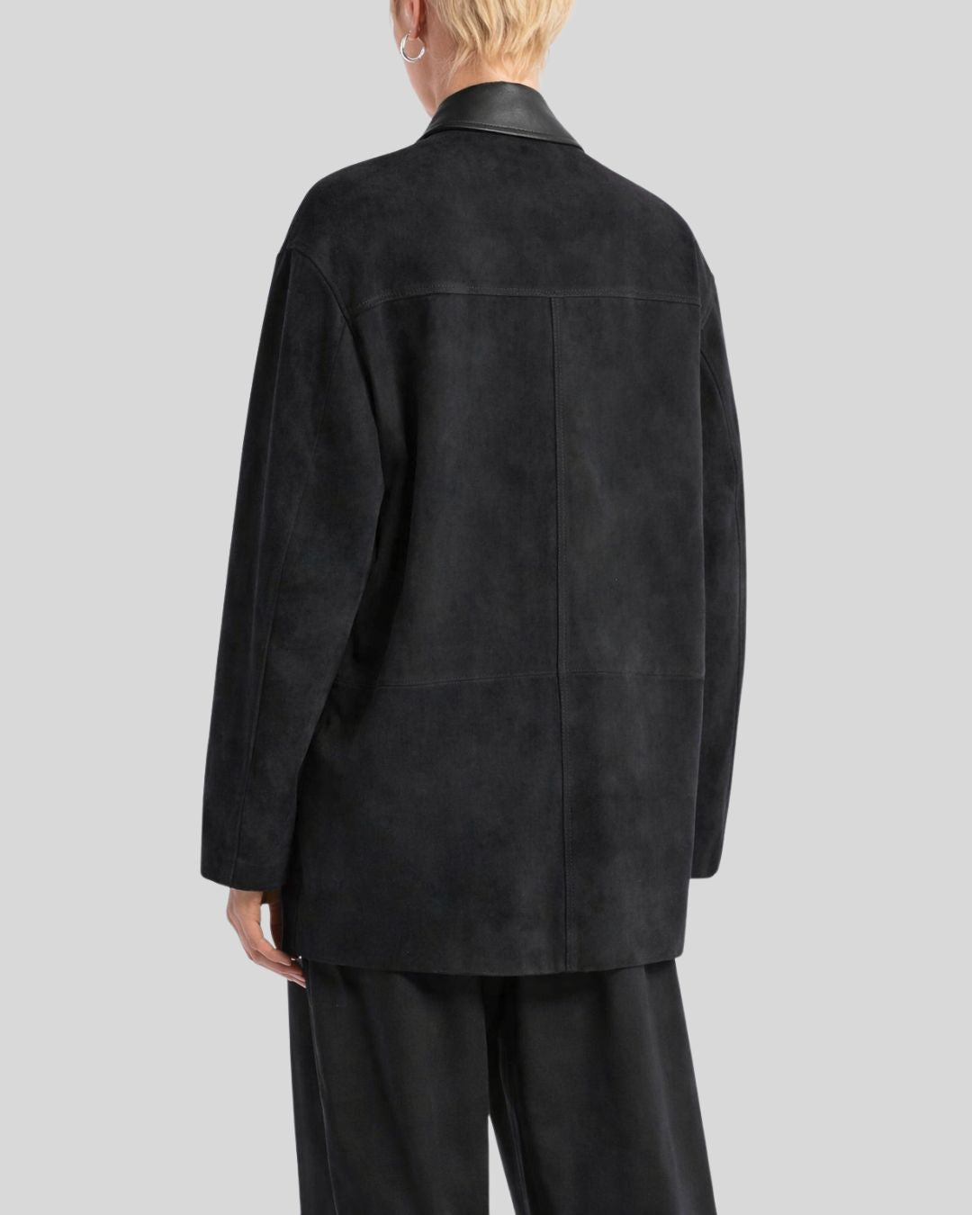 Front view of black button up suede jacket for women