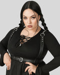 plus-size model wearing black leather body harness with chain straps over black dress
