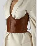 front close-up of brown leather corset belt on white blazer