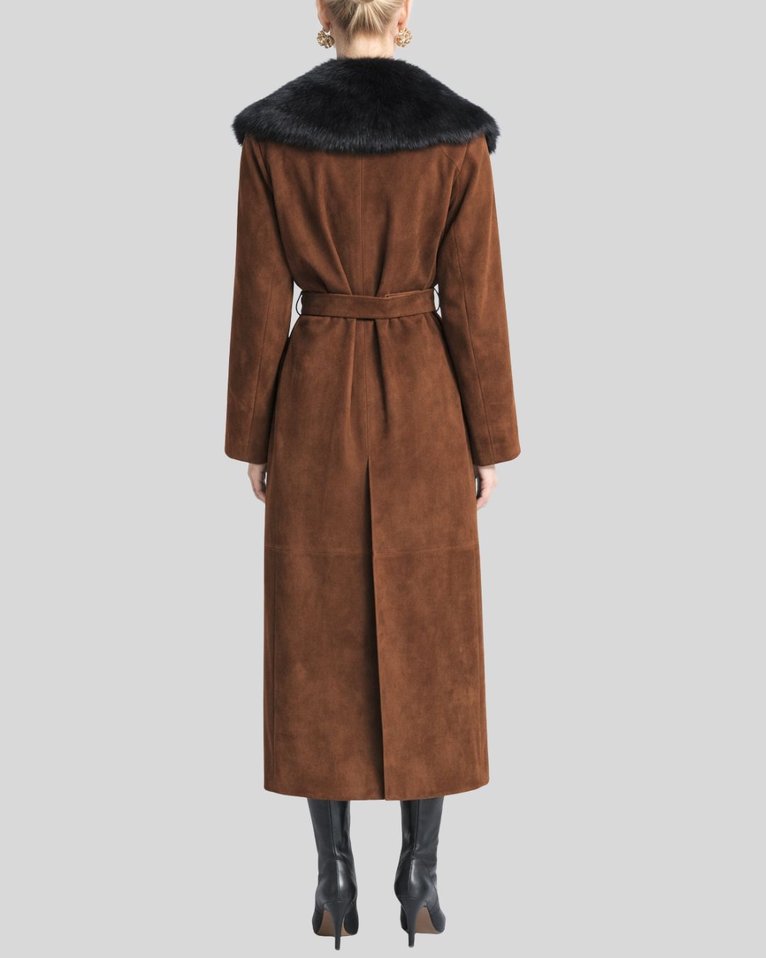 Woman wearing brown suede fur collar coat with belted waist and black boots