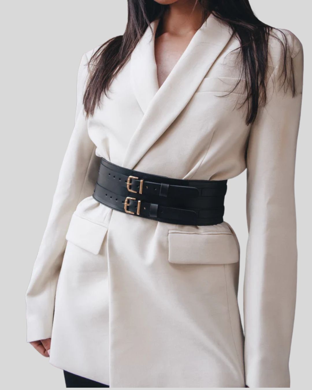 black leather waist belt layered over blazer styled in modern minimal look