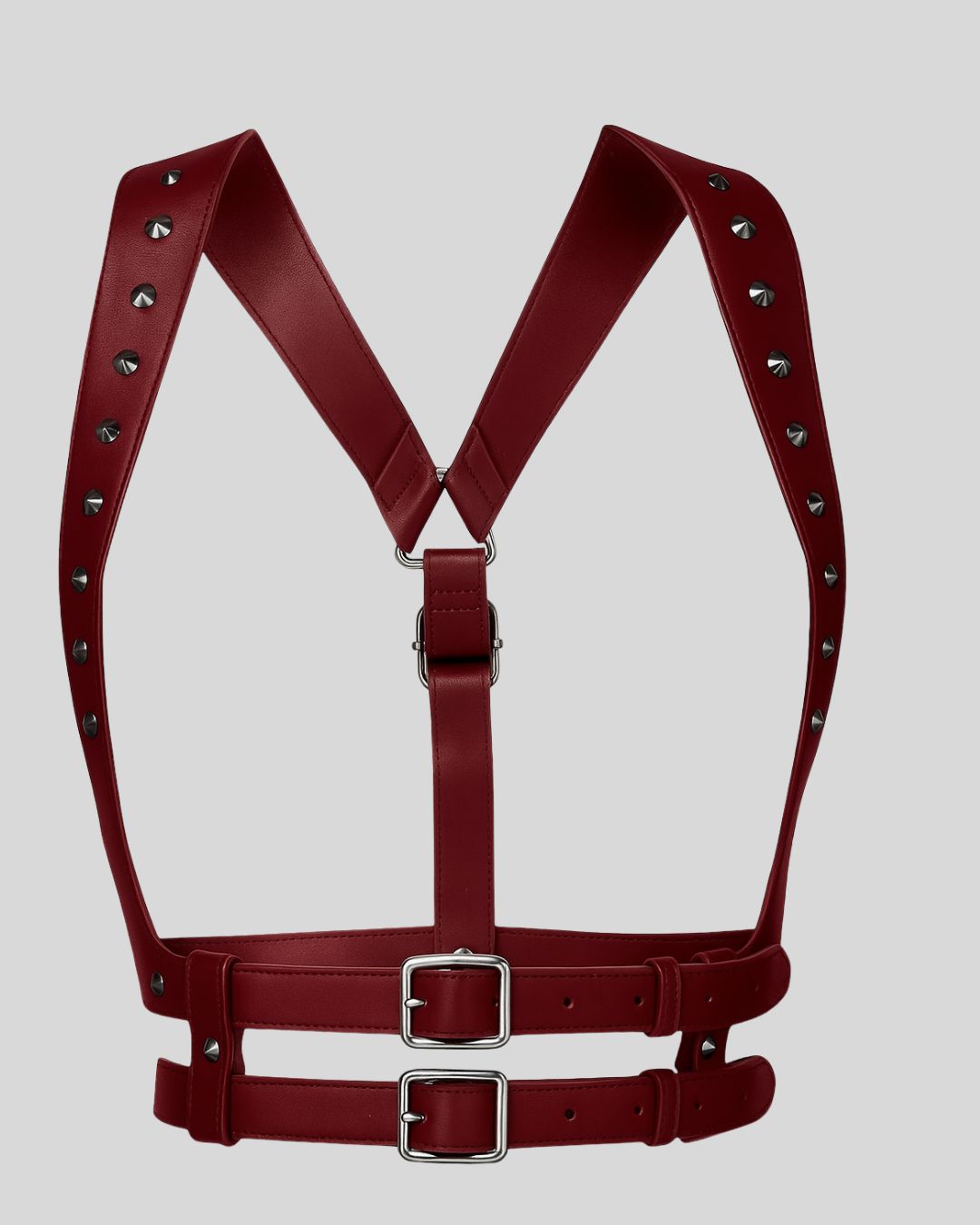 model wearing burgundy leather body harness with silver studs over distressed burgundy top