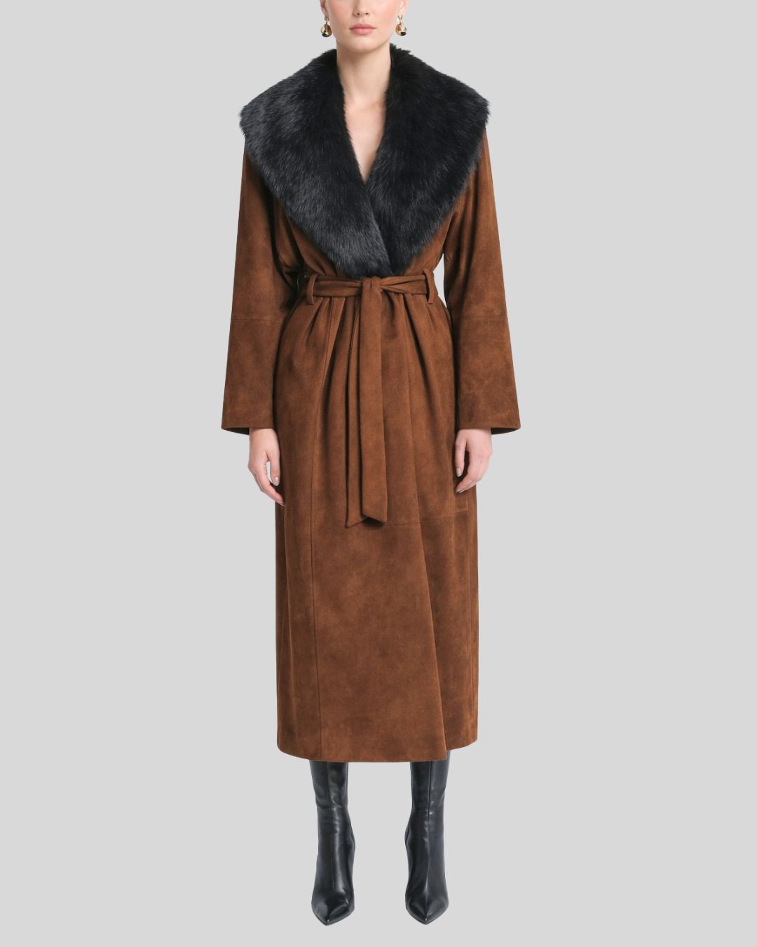 Woman wearing brown suede fur collar coat with belted waist and black boots