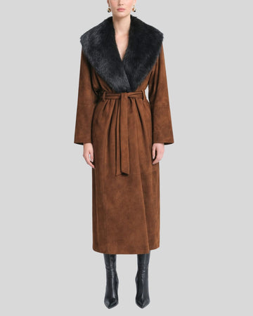 Woman wearing brown suede fur collar coat with belted waist and black boots