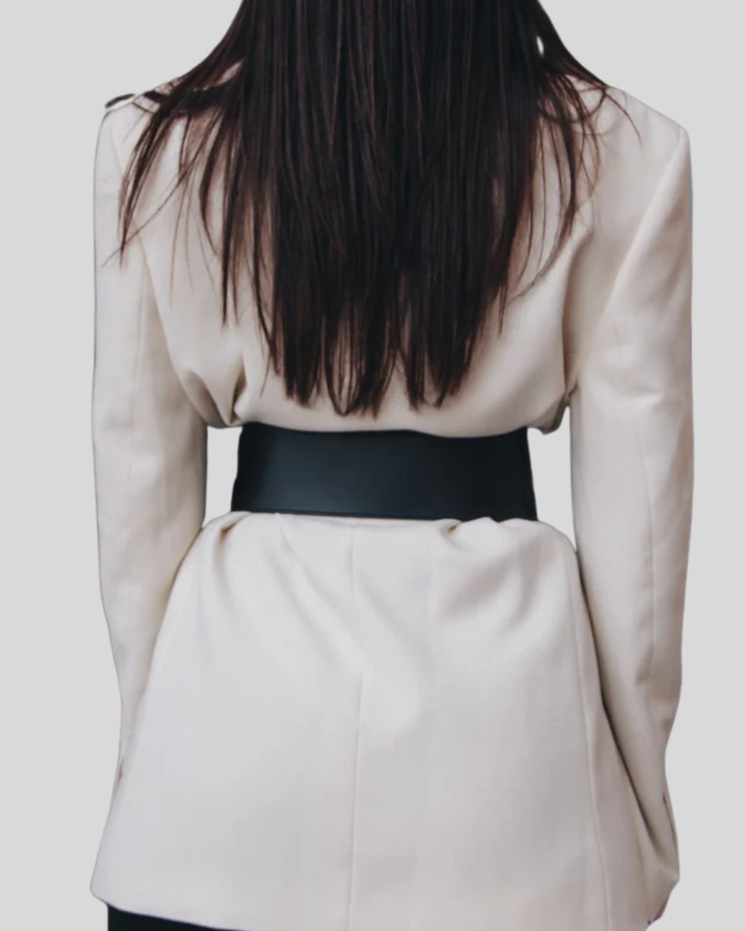 back view of wide black leather belt over cream blazer