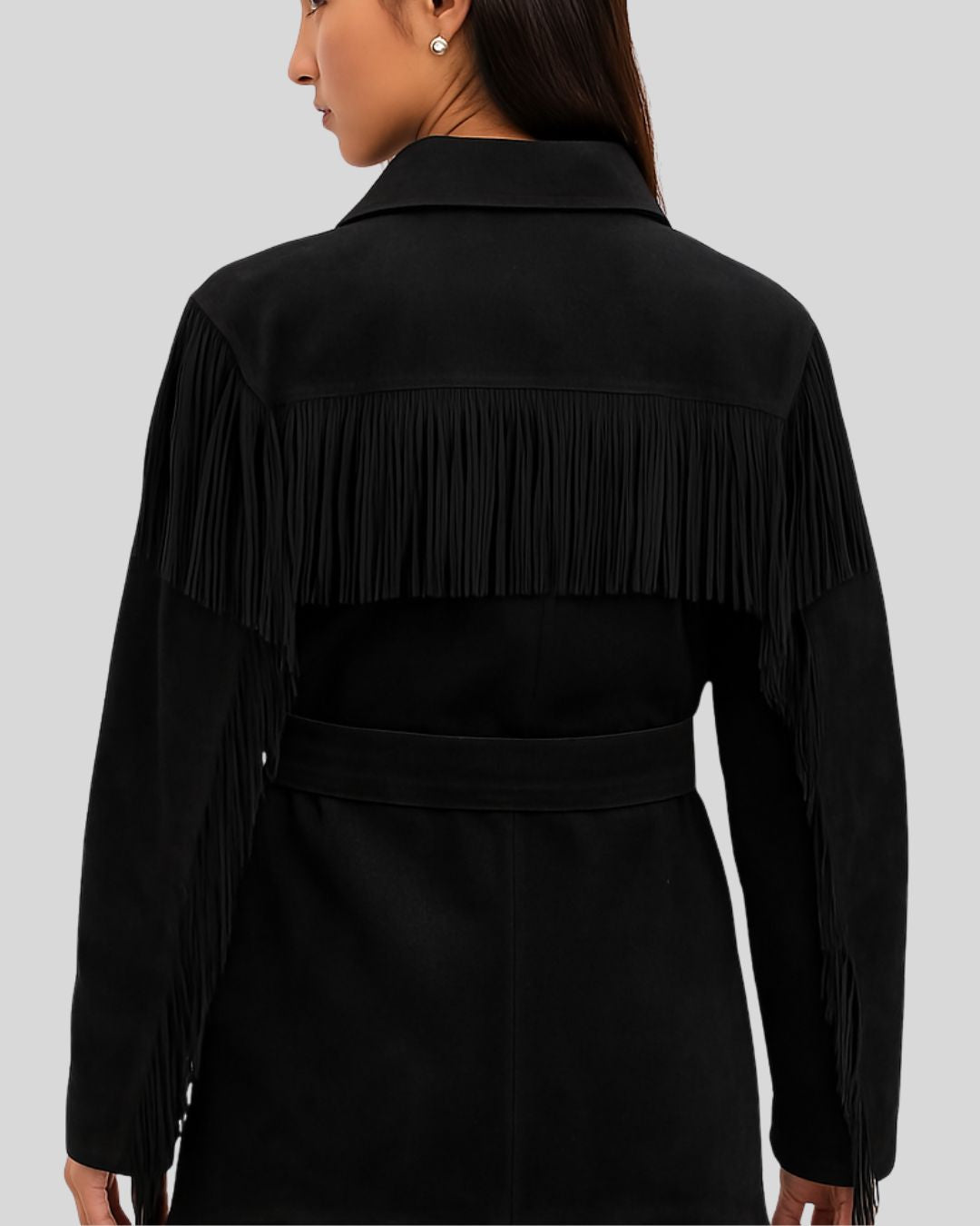  Back view of black suede women's jacket with long fringe and waist belt
