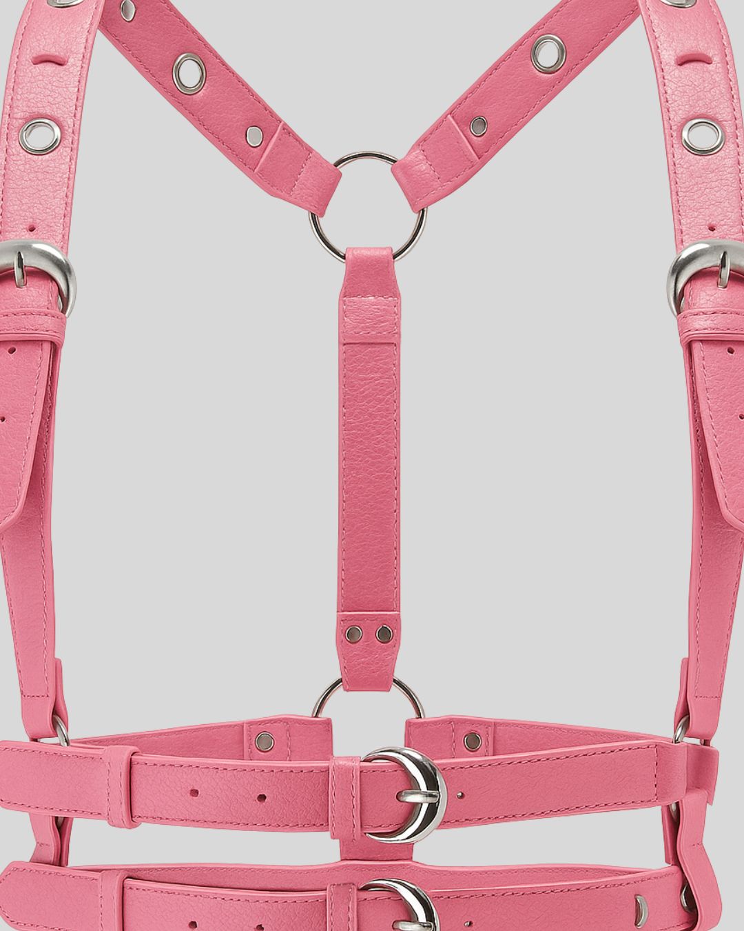close-up of pink leather harness center strap and silver O-ring with buckle details