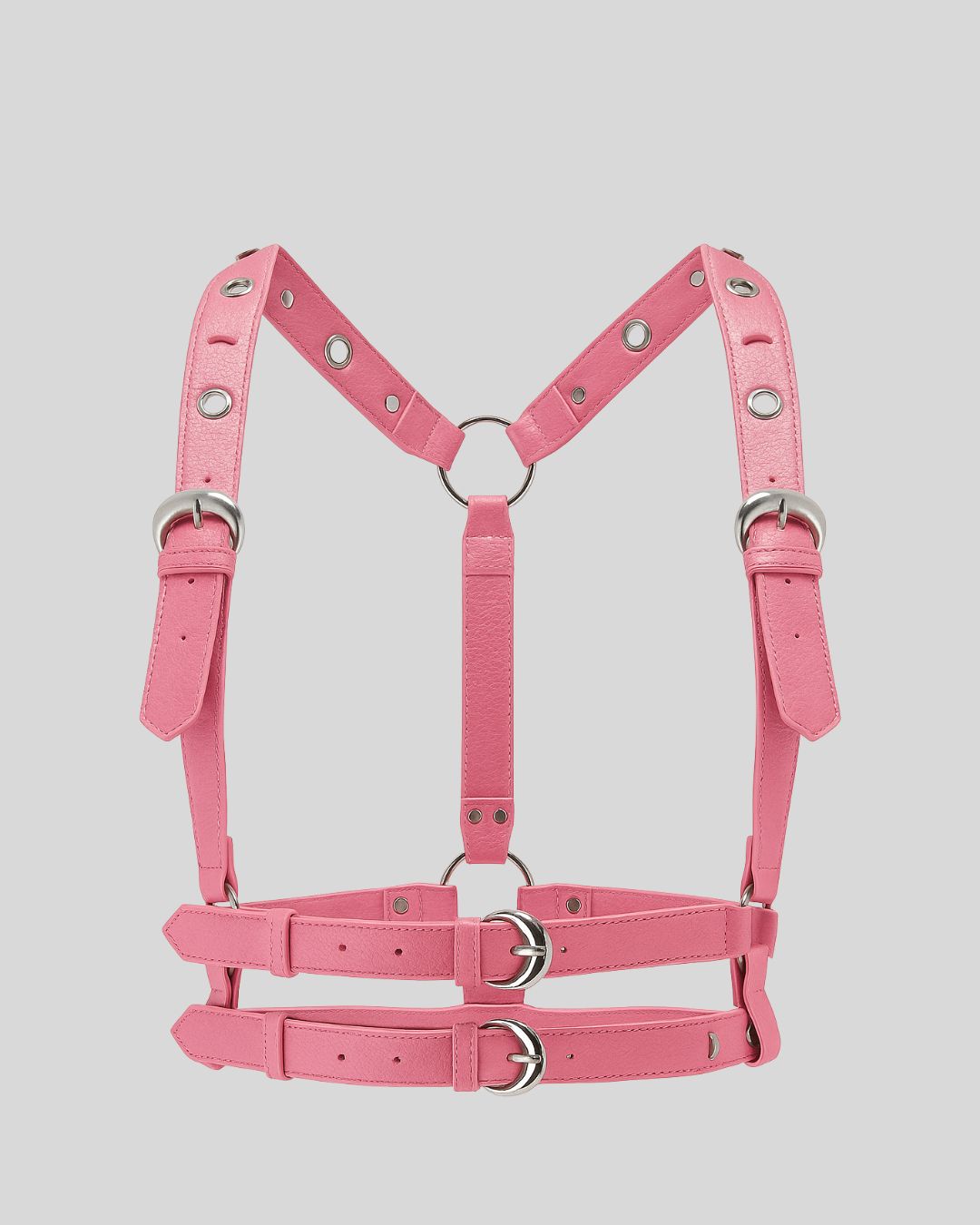model wearing pink leather body harness with double waist straps over pink dress