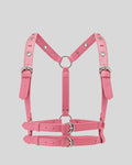 pink leather body harness laid flat with dual waist belts and silver O-rings