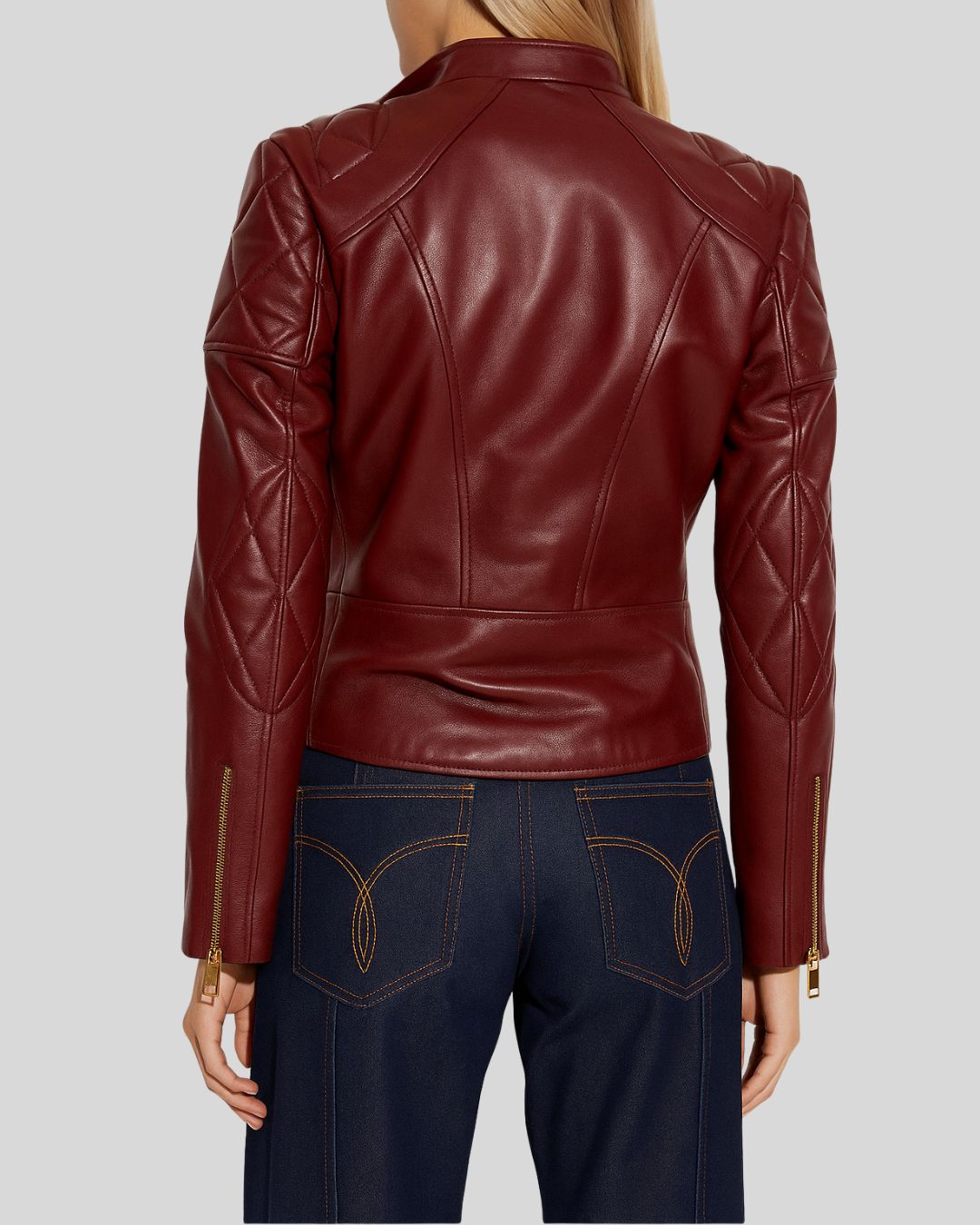 Front view of oxblood leather biker jacket for women with quilted shoulders and gold zippers