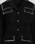 Black jacket with silver studs on a plain background