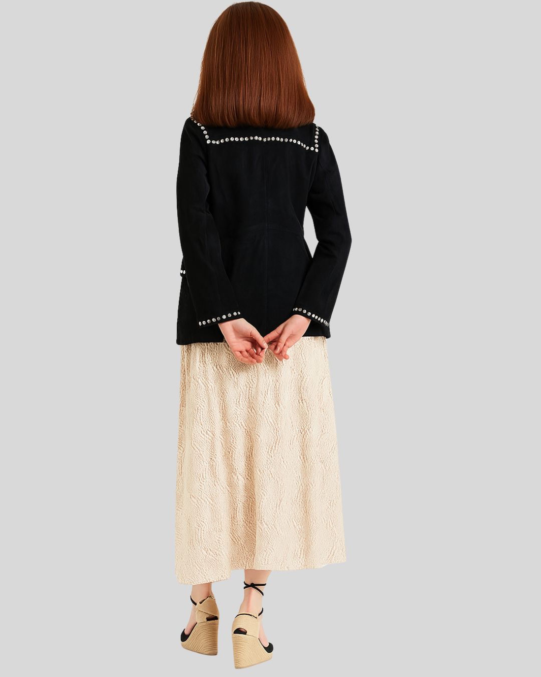 Black jacket with silver studs on a plain background