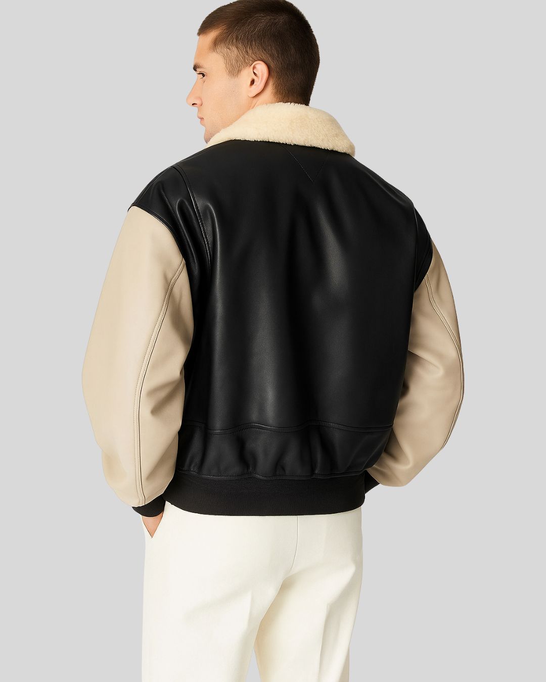 Front view of beige shearling collar leather jacket with contrast sleeves