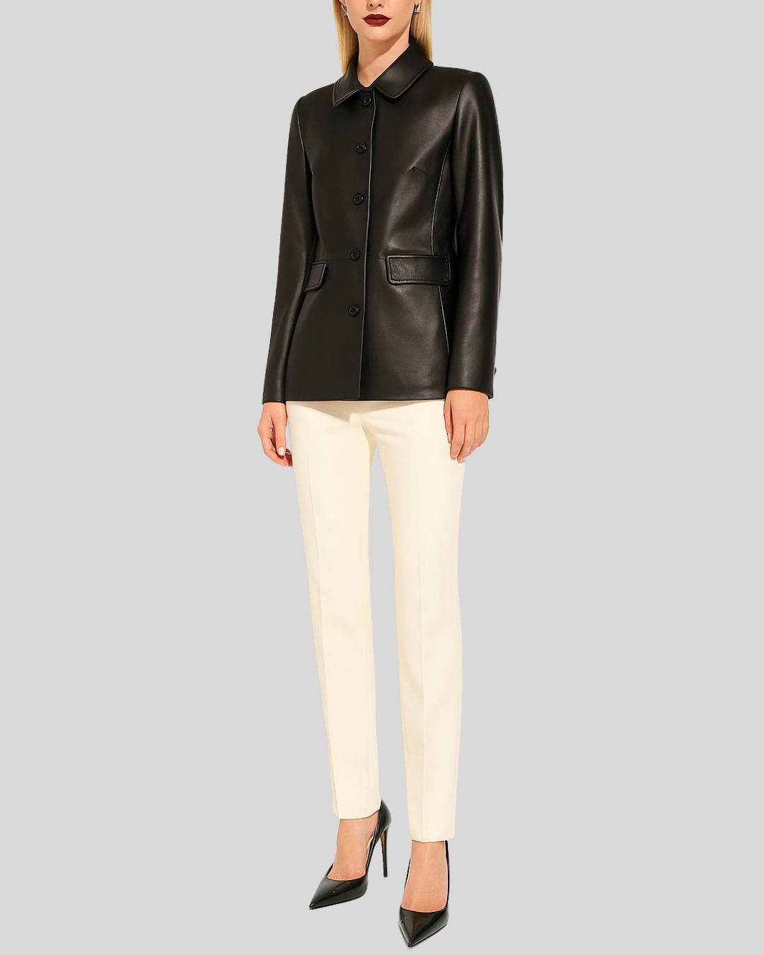Woman wearing black leather blazer jacket with Peter Pan collar and ivory trousers