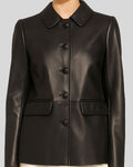 Detailed front mid-shot of women’s black leather blazer with flap pockets