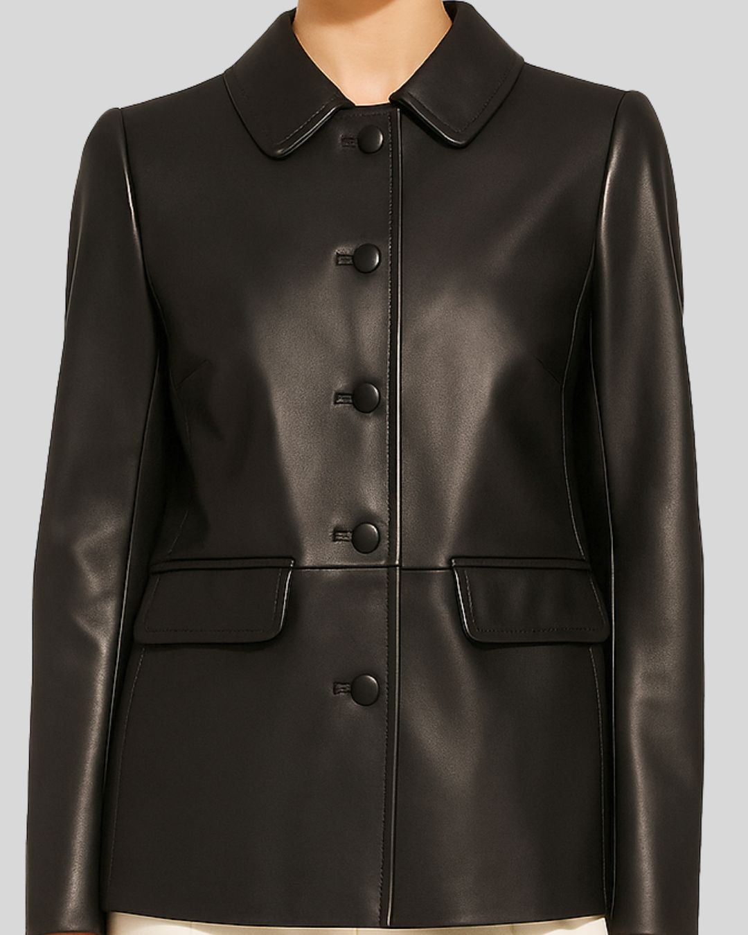 Detailed front mid-shot of women’s black leather blazer with flap pockets