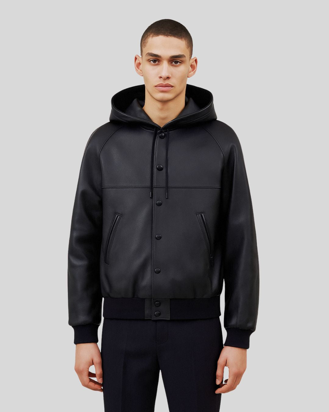 Front view of black leather bomber jacket with hood for men