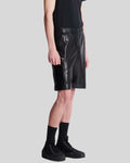 Black leather cargo shorts men side view highlighting zipper pocket detail