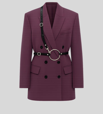 woman wearing black leather O-ring harness over purple blazer