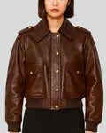 Brown leather bomber jacket for women with gold snap buttons – front view
