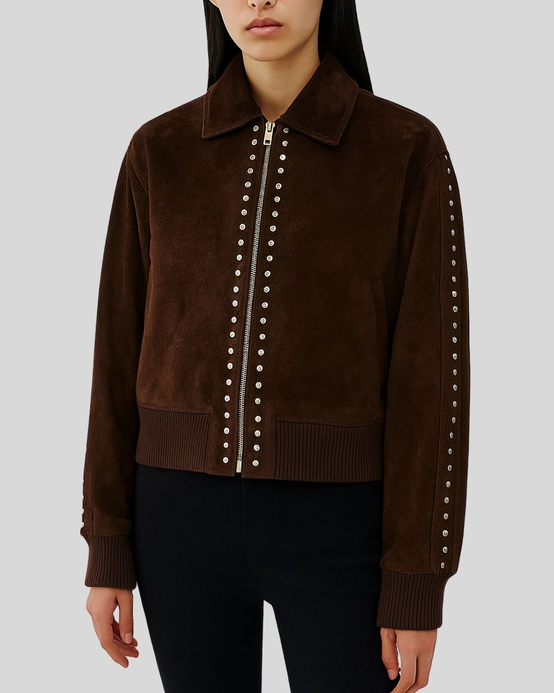  Woman wearing dark brown suede bomber jacket with silver studded zip

