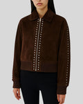  Woman wearing dark brown suede bomber jacket with silver studded zip


