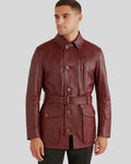 Front view of model wearing burgundy leather safari jacket with belt