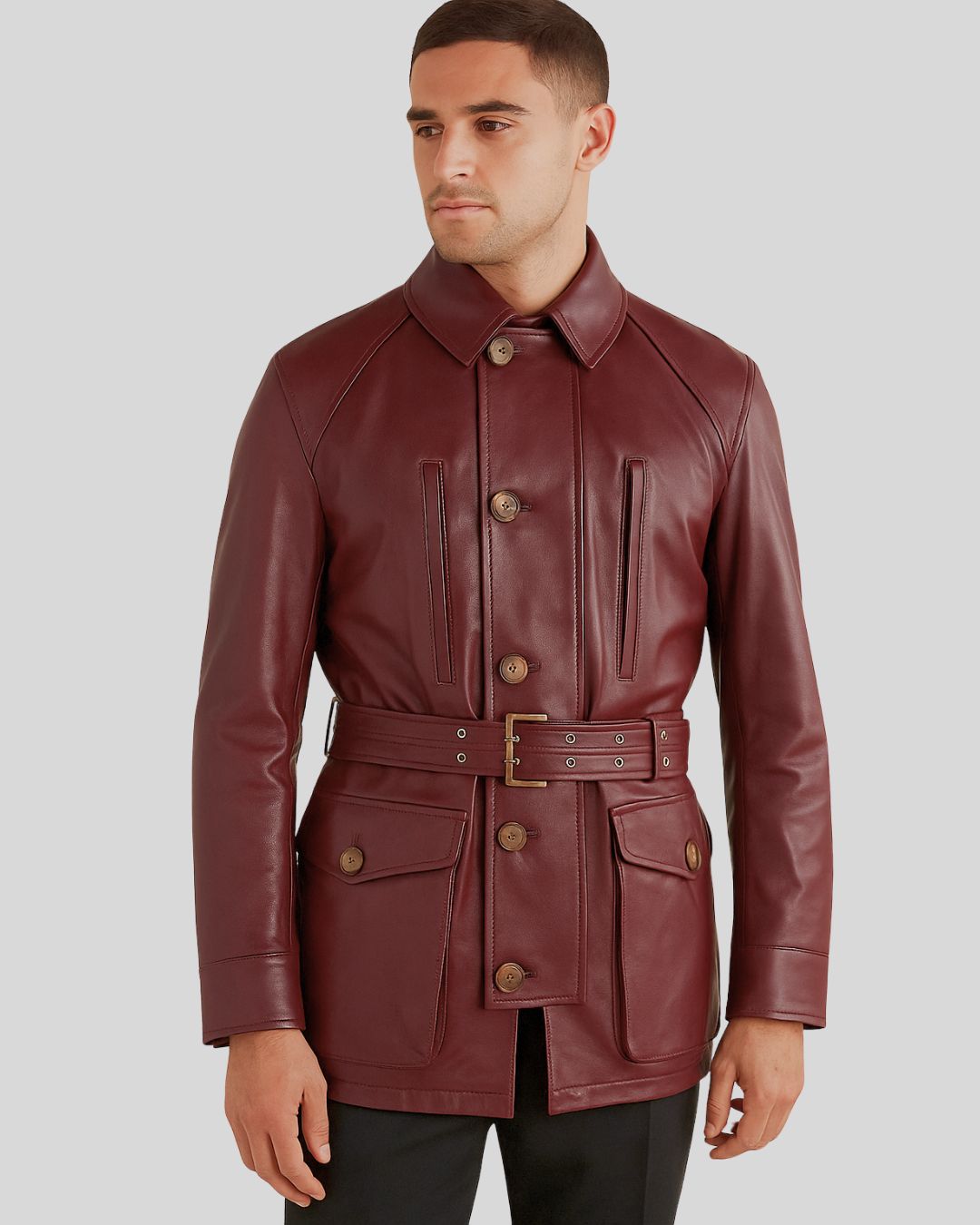 Front view of model wearing burgundy leather safari jacket with belt