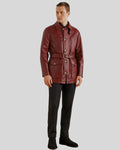 Full body view of burgundy safari coat styled with black trousers