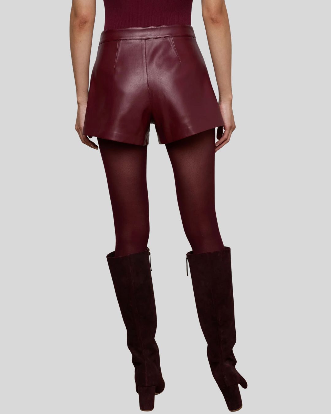 Front view of women’s burgundy leather shorts with gold buttons