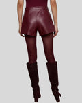 Back view of women’s burgundy high waisted leather shorts
