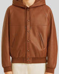 Snap-button closure and welt pocket close-up on brown bomber jacket