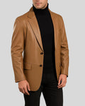 Model in tan leather blazer over black turtleneck – formal outfit idea