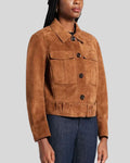 Woman wearing cropped suede jacket with belt and patch pockets
