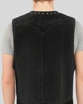 Zoomed-in look at the suede texture and studs on vest back