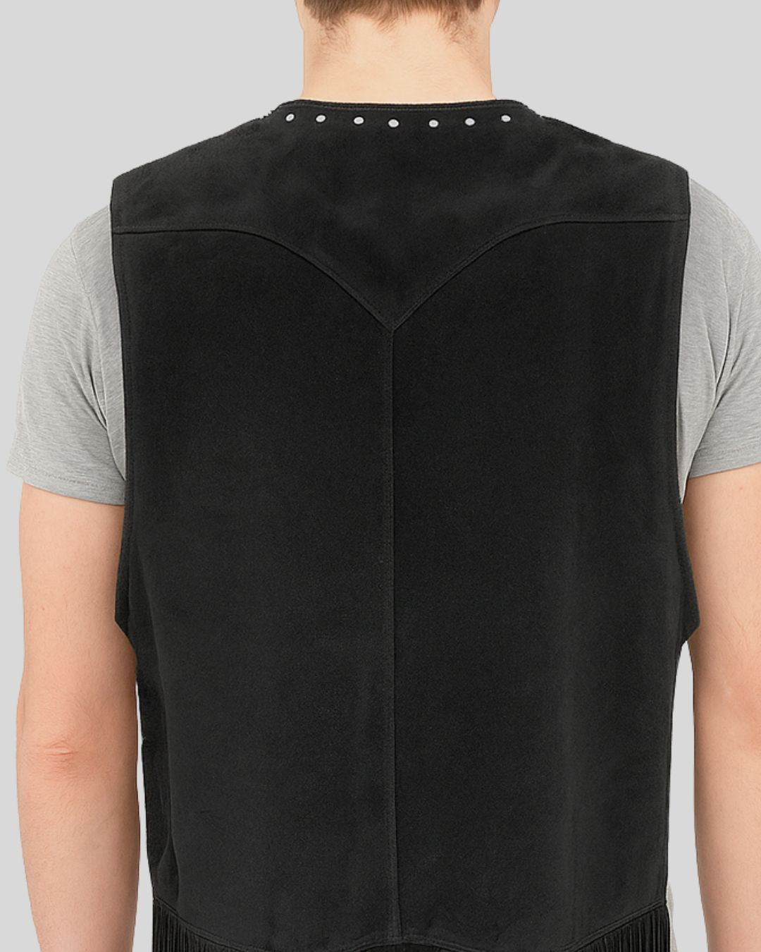 Zoomed-in look at the suede texture and studs on vest back