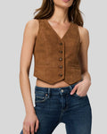 Woman wearing a brown suede leather vest with front button closure
