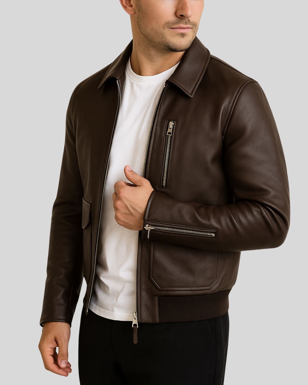 Close-up angle of brown leather bomber chest and zipper