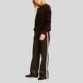 side view of Espresso Stride brown leather pants with stripe detail