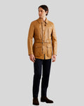 Man wearing full camel leather safari coat with black pants