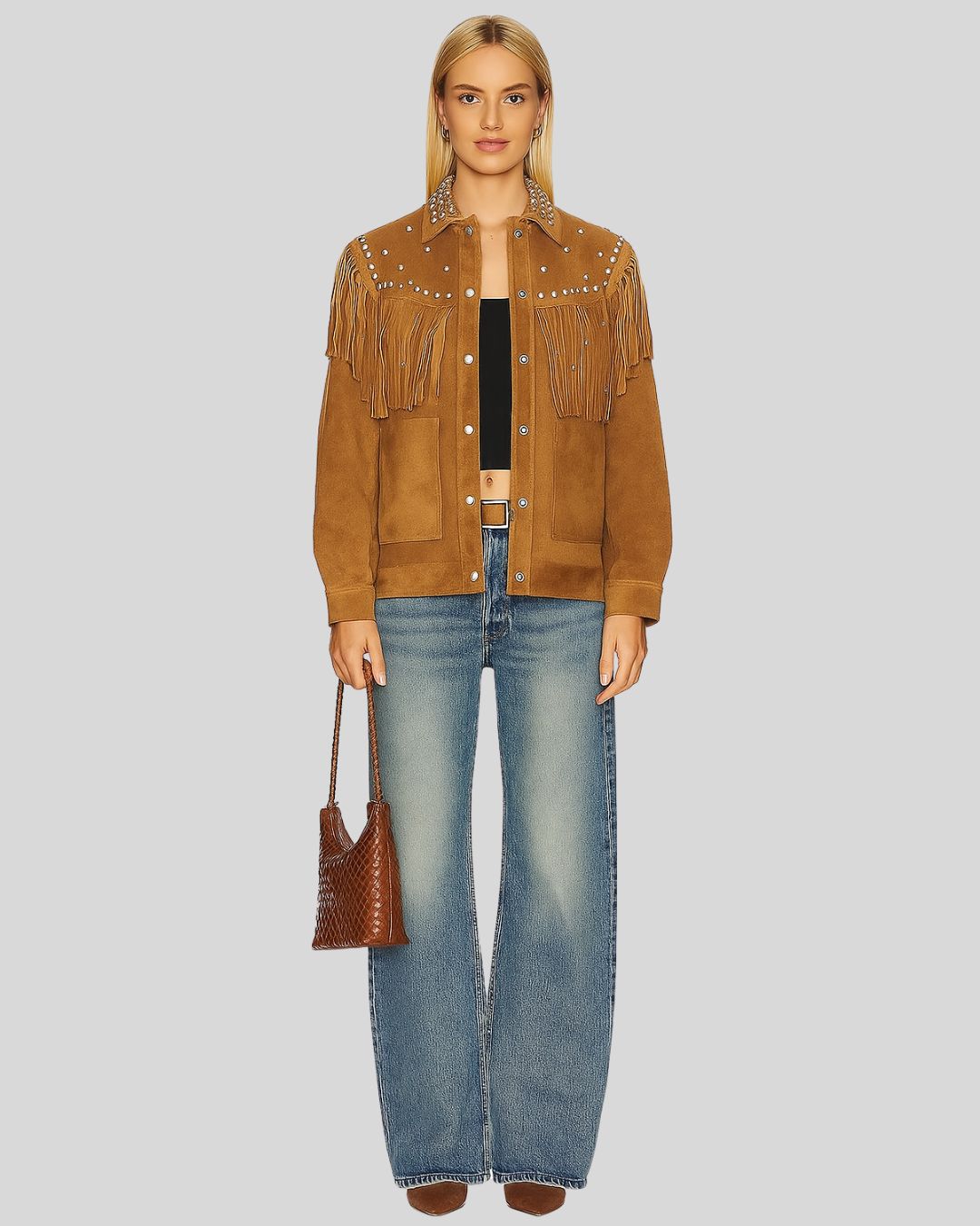 Full body view of model wearing tan fringe suede jacket with flared jeans