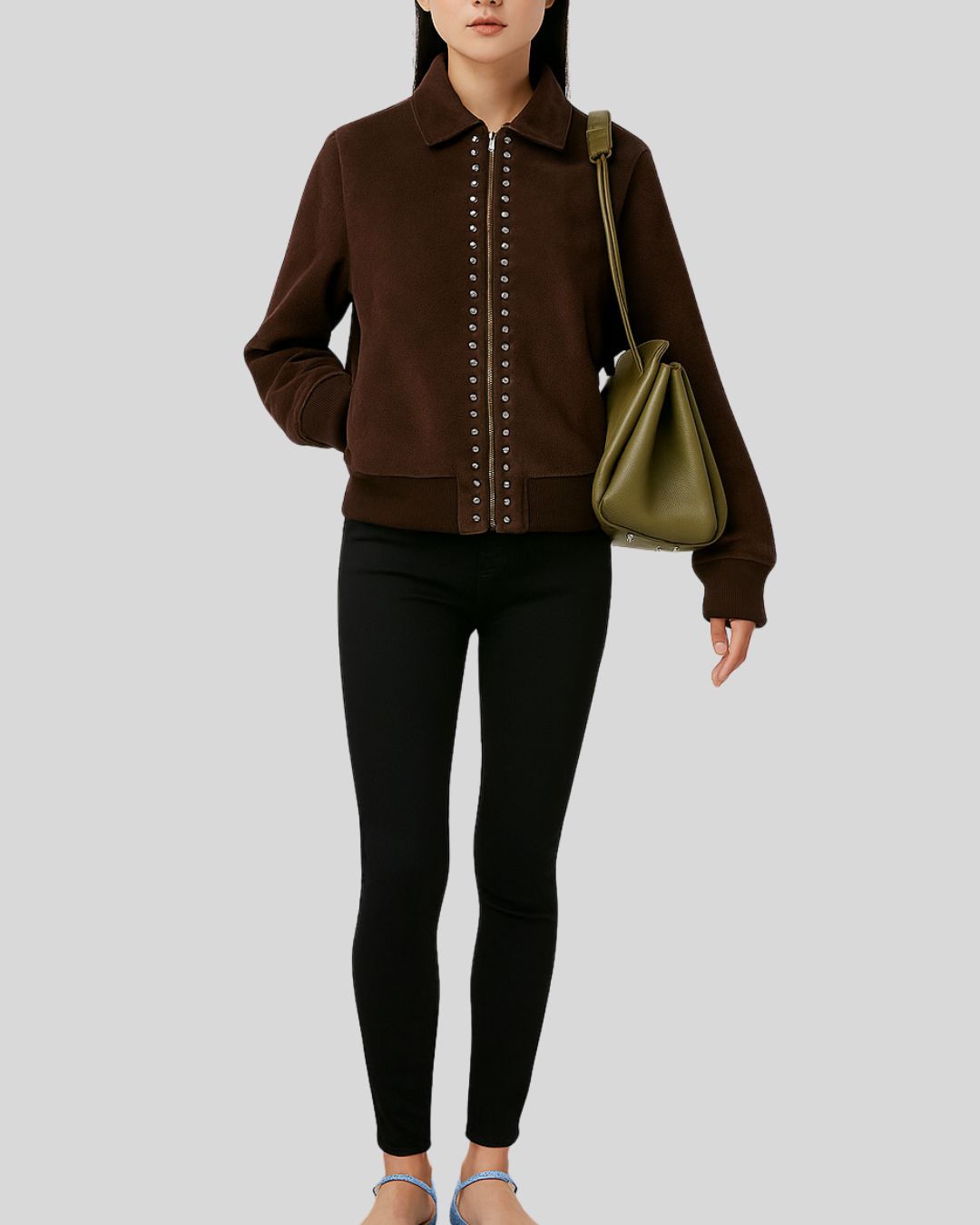  Woman wearing dark brown suede bomber jacket with silver studded zip


