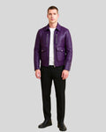 Full body image of man wearing purple leather utility bomber with black pants