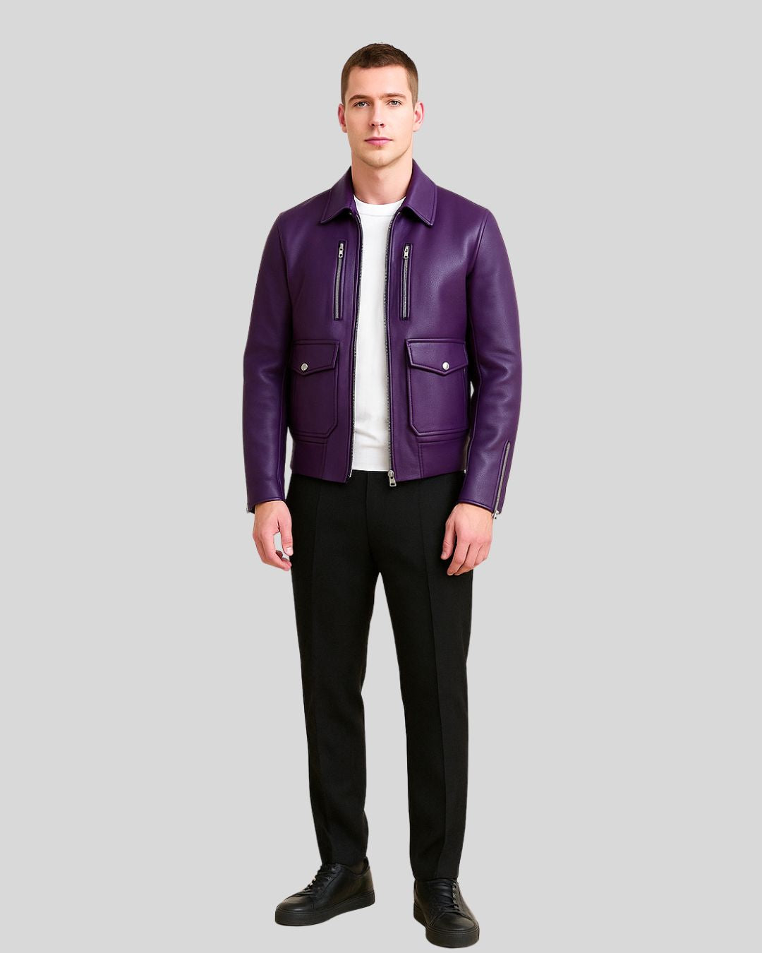 Full body image of man wearing purple leather utility bomber with black pants