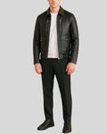 Model wearing black leather utility bomber jacket and pants