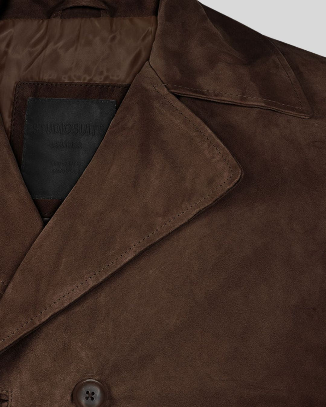 Peak lapel collar detail in dark brown suede