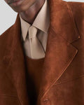 Close-up of notch lapel and suede texture on brown trench coat