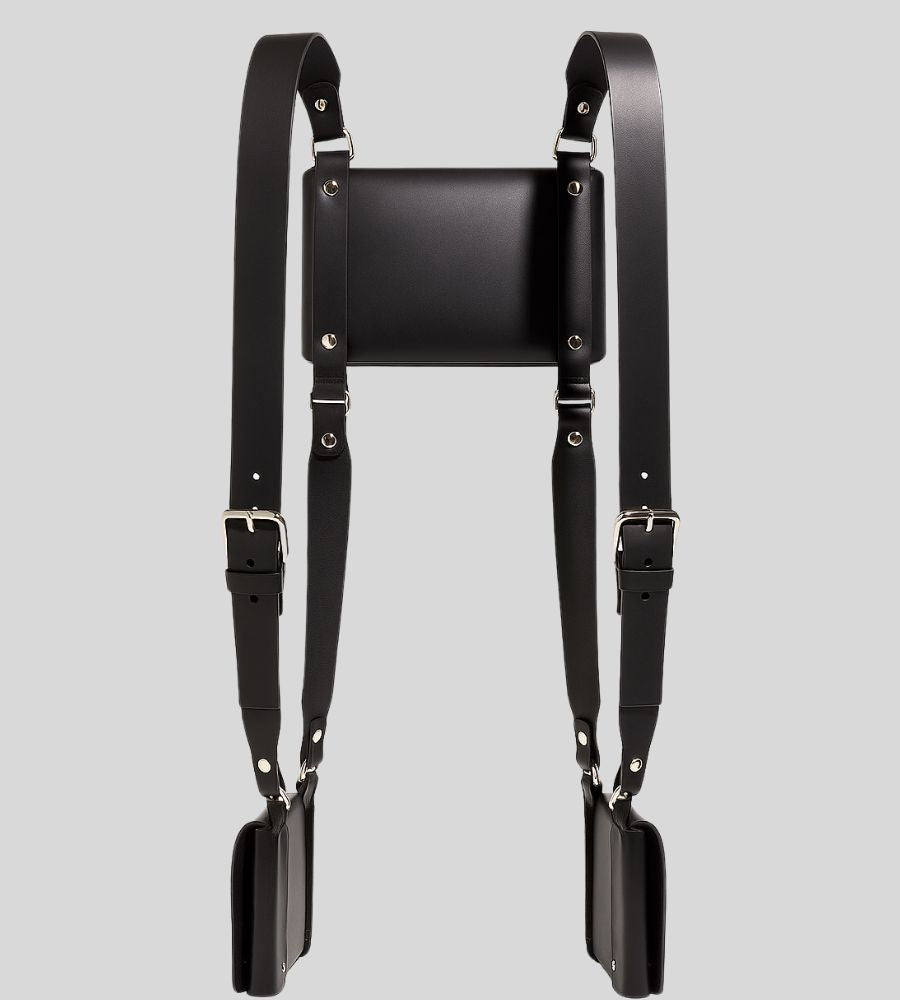 flat lay of leather shoulder harness holster with triple pouch