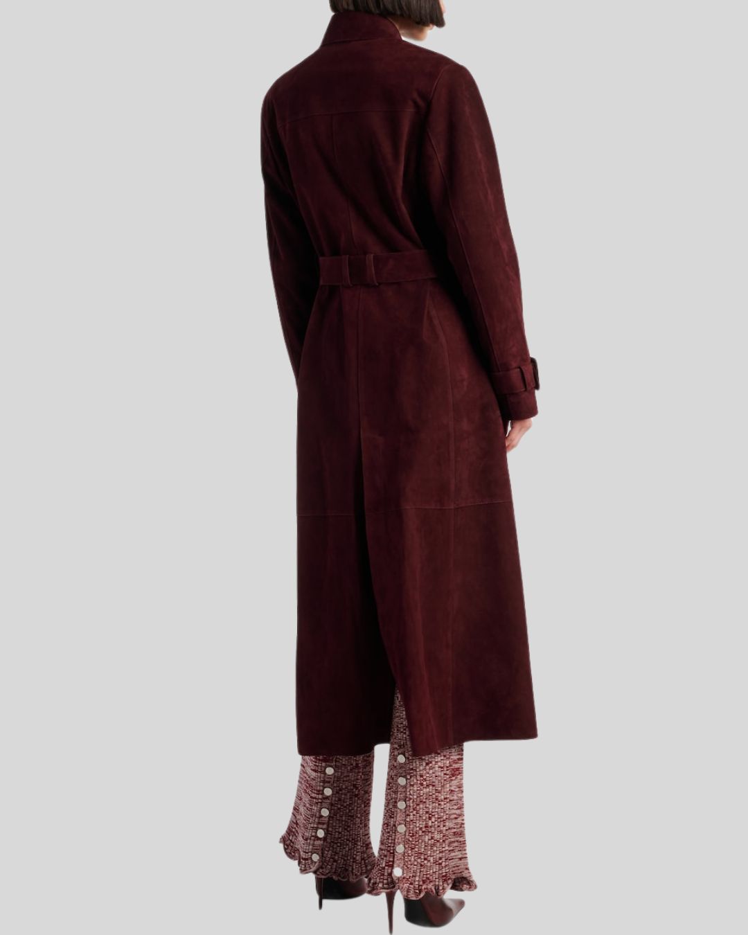  Back view of long burgundy suede trench coat with tailored seam
